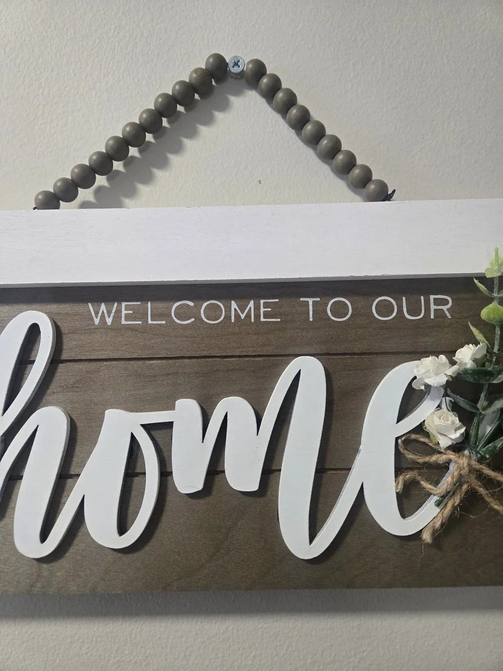 Welcome to Our Home Wooden Wall Sign - White Script on Brown